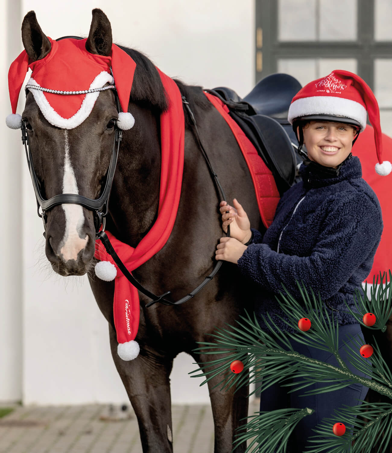 Person in equestrian gear with a horse wearing a red and white festive outfit, surrounded by Christmas decorations.