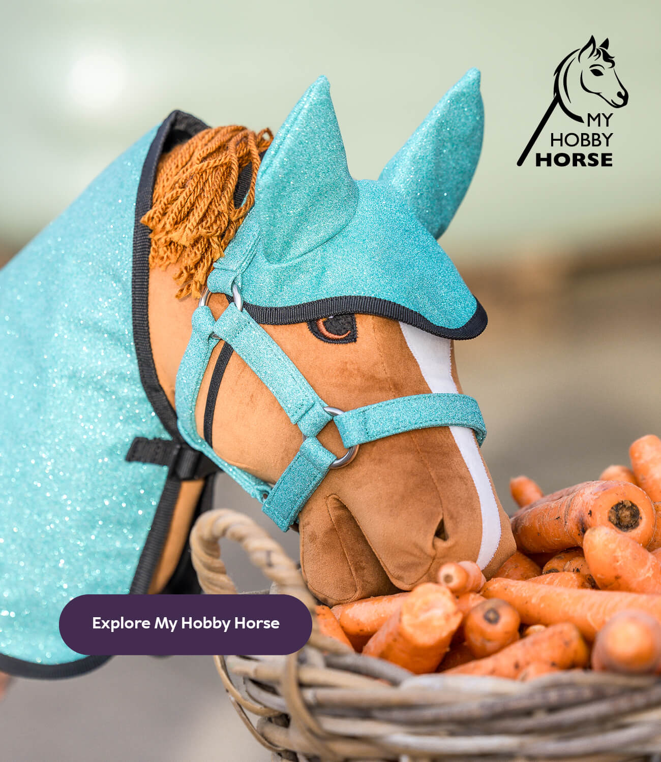 My hobby horse with turquoise glittery mane and bridle, surrounded by carrots, on a blurred background with 'My Hobby Horse' branding.